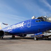 a blue airplane on the tarmac
