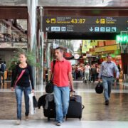 a group of people walking with luggage in a terminal