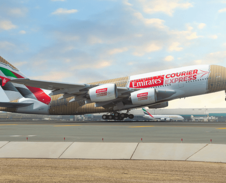 An Emirates Airbus A380 featuring the 'Courier Express' livery taking off from DXB